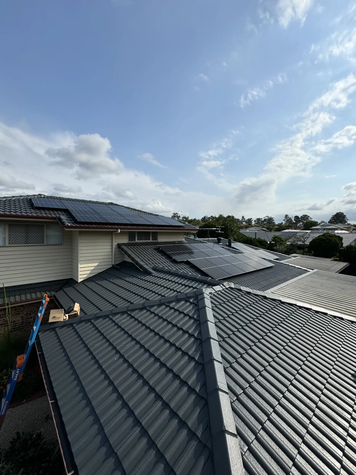 Solar panels being installed across a residential roof