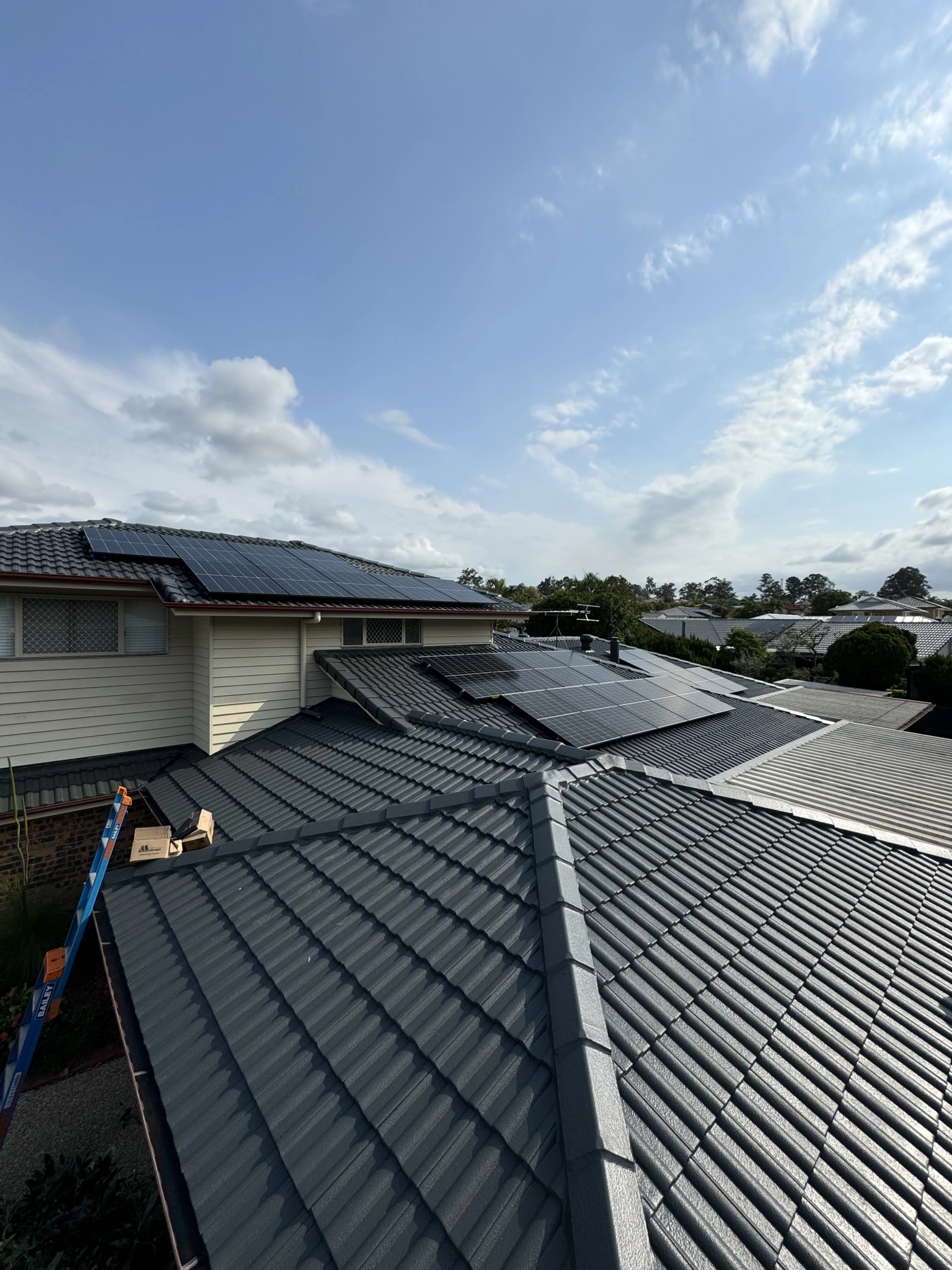 Solar panels being installed across a residential roof