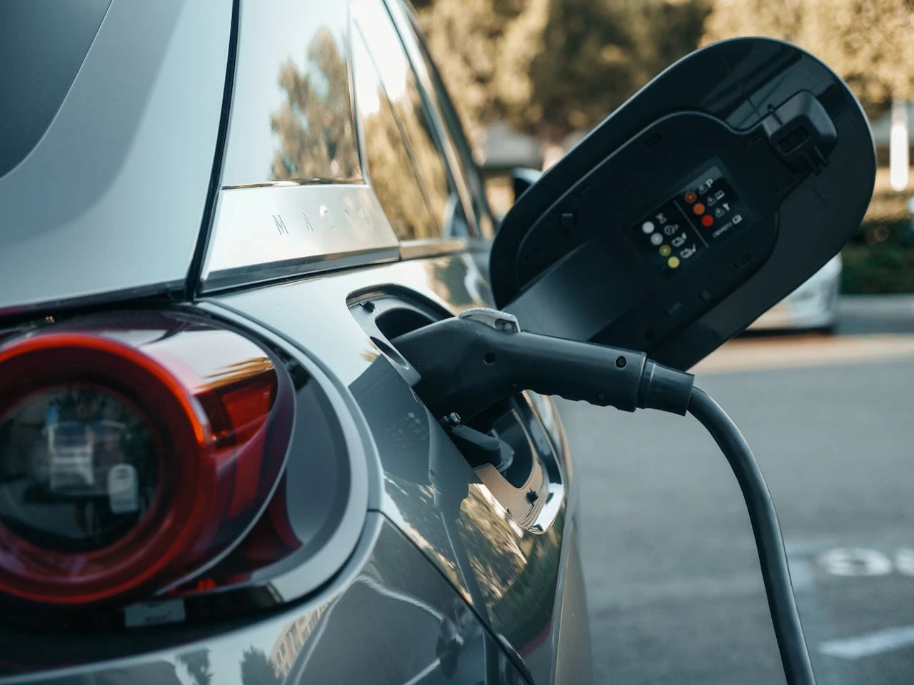 An electric vehicle charging from a wall-mounted home charger